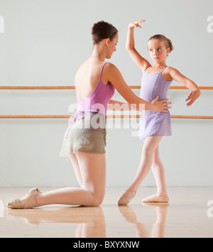 Female instructor training ballet dancer in dance studio