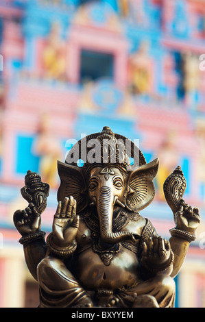 Bronze ganesha statue in front of Sathya Sai Baba's Gopuram ashram gate. Puttaparthi, Andhra Pradesh, India Stock Photo