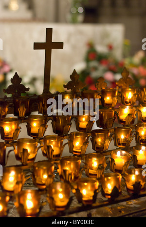 Cross with candles in cathedral Stock Photo