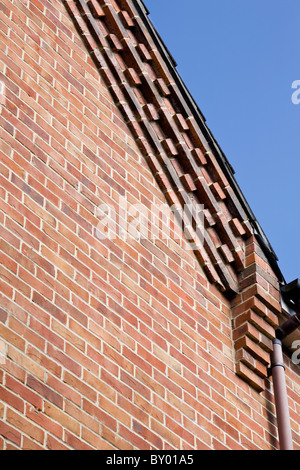 Close-up of decorative brickwork forming part of the gable end of a house ending in a brick corbel. Stock Photo