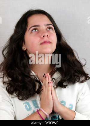 Young teen praying, UK Stock Photo
