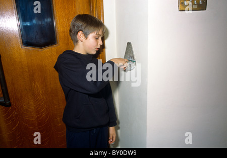 St Bernard's Catholic Church Lingfield Boy Dips Fingers Into Holy Water Stock Photo
