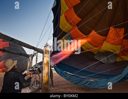 Pilot Astrid Gerhardt prepares this hot air balloon for take-off in Namib-Naukluft Park, Namibia. Stock Photo