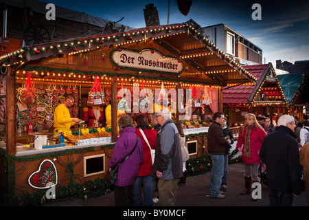 UK, England, Yorkshire, Leeds, Milennium Square, Christkindelmarkt, shoppers browsing confectionery stall Stock Photo