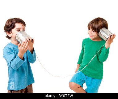 Two boys talking on a tin can phone isolated on white Stock Photo