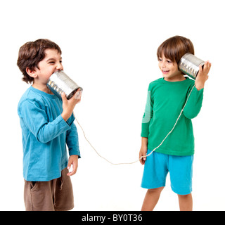 Two boys talking on a tin can phone isolated on white Stock Photo