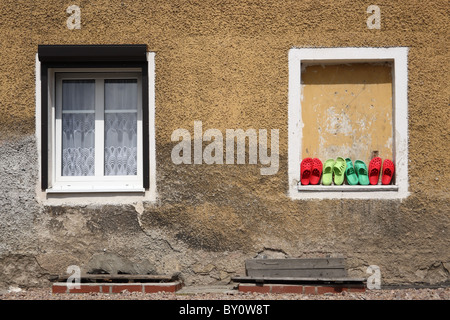 Row of clogs against the wall. Stock Photo