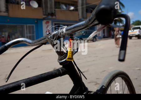 NAMPULA, MOZAMBIQUE, May 2010 : A charcoal transporter carries his puncture repair kit on his handlebars. Stock Photo