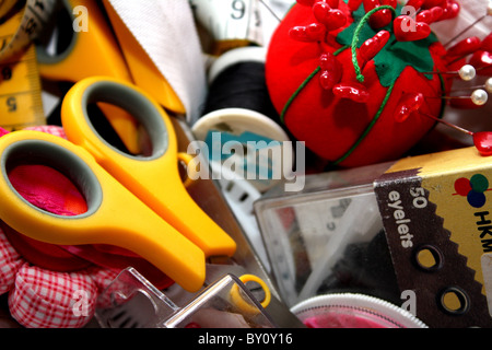 A group of sewing accessories and haberdashery in a tailors and dressmakers sewing box Stock Photo