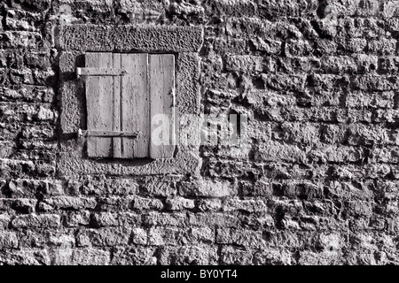 Shuttered Window in Stone Wall Stock Photo - Alamy