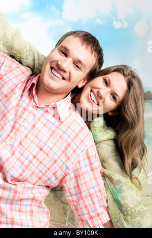 Photo of carefree couple holding each other’s hands and looking at camera with smiles Stock Photo