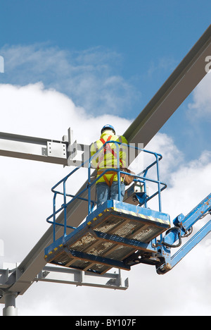 Construction worker inspecting steel beams on a platform Stock Photo