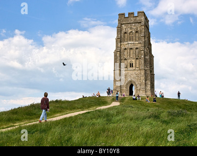 Woman and raven at St. Michaels Tower on the summit of Glastonbury Tor in Somerset England Stock Photo