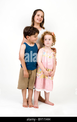 three kids posing to camera isolated on white Stock Photo
