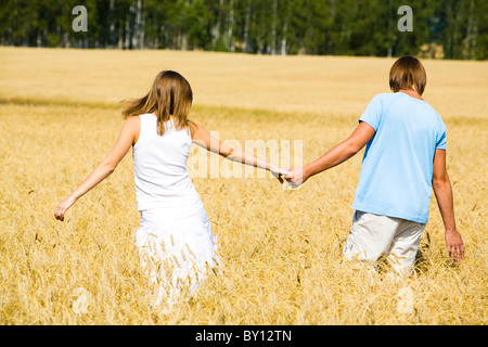 Rear view of couple holding by hands Stock Photo