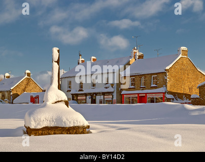 View of Goathland showing shops and war memorial in deep snow. Stock Photo