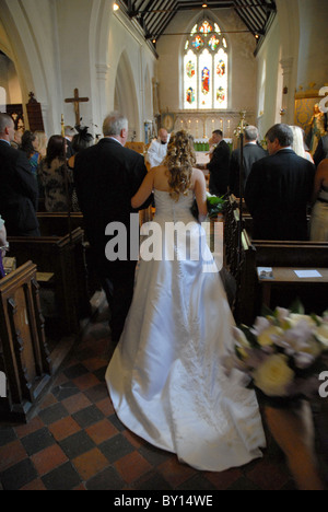 A Bride being lead down the aisle by her father Stock Photo