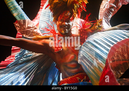 Individual competition, Rainbow -winged  male dancing masquerader with feathered headdress Stock Photo