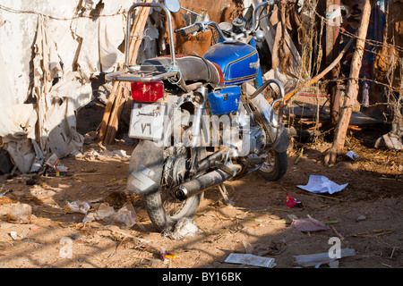 Motor Bike parked outside the weekly Camel and Cattle market near Luxor, Egypt Stock Photo