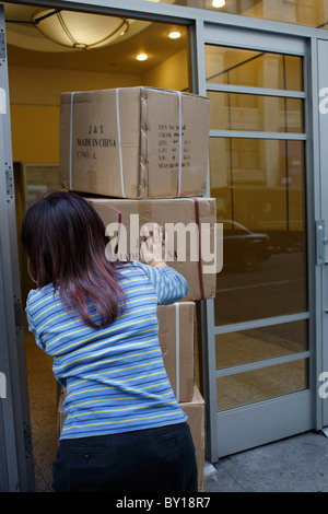 Cartons are shoved into a room, New York City, United States of America Stock Photo