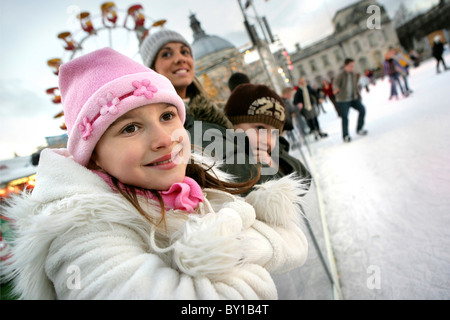 Family watching people on the Ice rink at The Winter Wonderland. Stock Photo