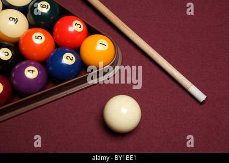 billiard pool table with cue stick triangle and balls close up Stock Photo