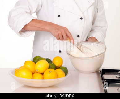 CHEF WHISKING EGG WHITES Stock Photo