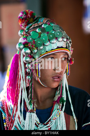 Myanmar, Burma, Keng Tung (Kyaing Tong). Young Akha girl wearing beautiful headdress decorated with silver coins and baubles, Stock Photo