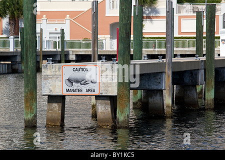 Caution Manatee Area sign on end of pier in waterway, West Palm Beach, Florida, USA Stock Photo