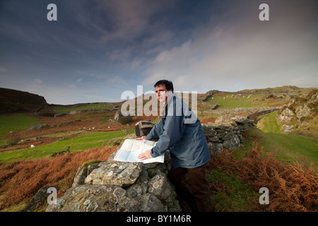 Walker map reading on the Mawddach Way Wales Stock Photo