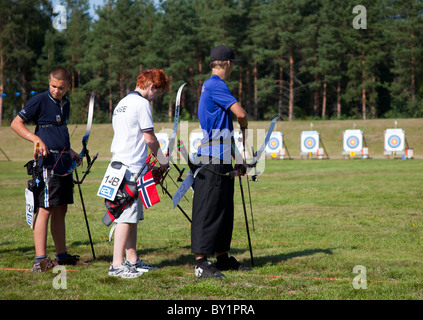 Three young archers shooting in competition between the Cap of the North countries ( Finland, Sweden, Norway) , Finland Stock Photo