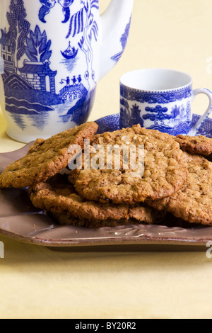 Close-up of oatmeal cookies and a tea pot and cup Stock Photo