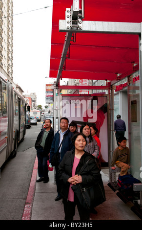 Chinatown San Francisco Chinese residents waiting for bus in shelter Stock Photo