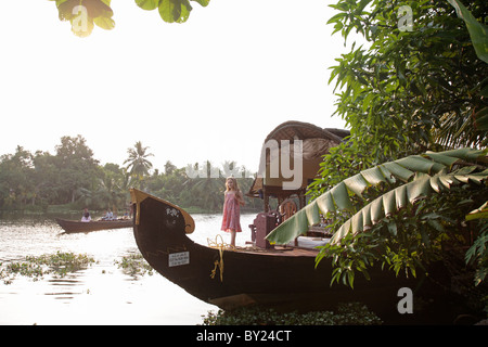 India, Kerala. Young girl on a houseboat in the Kerala Backwaters. (MR) Stock Photo