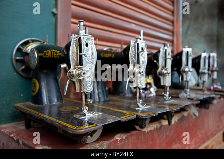 India, Mysore. Recently-repaired sewing machines lined up outside a sewing-machine repair shop in Mysore. Stock Photo