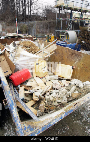 Skip onsite with waste materials not segregated for recycling - bad practice. Stock Photo