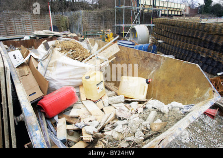 Skip onsite with waste materials not segregated for recycling - bad practice. Stock Photo