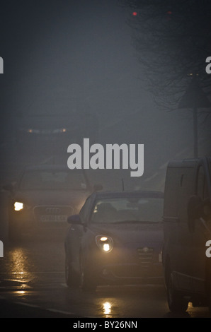 Cars driving in thick fog Stock Photo