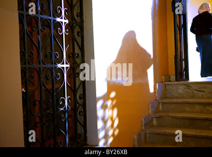 Tripoli, Libya, Tripolitania; A young veiled Muslim woman walking along the corridors of a 'madrasa' (school) in the city centre Stock Photo
