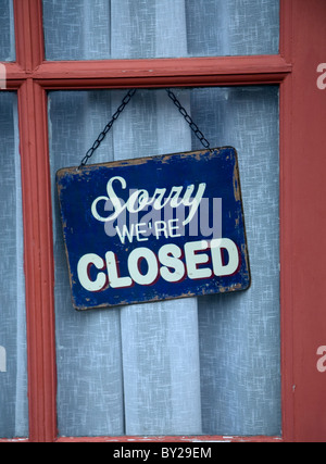 Old Sorry we are Closed shop sign in window Stock Photo