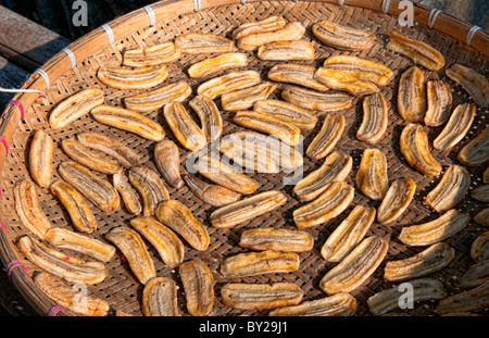 Luang Phabang Laos Lao drying cooked bananas in sun on road tray Asia Asian Stock Photo