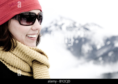 A woman smiling while in the mountains. Stock Photo