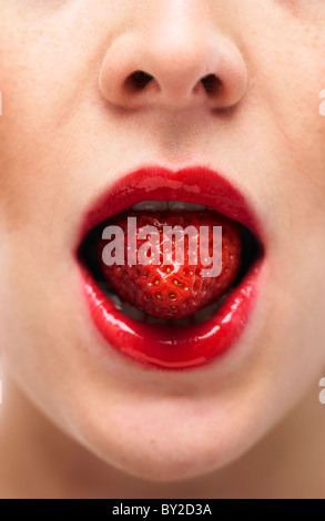 white woman biting on a stawberry