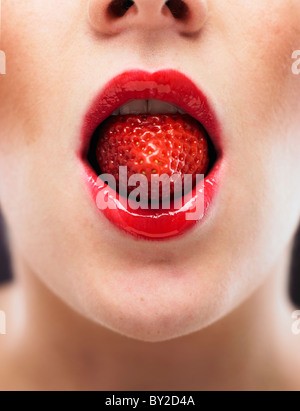 white woman biting on a stawberry