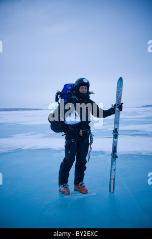 A young man exits the Missori River after a long day of snowkiting during the 2XtM expedition Stock Photo