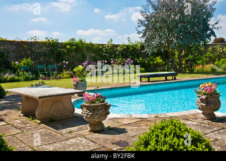 An outdoor swimming pool in an English country summer garden Stock Photo