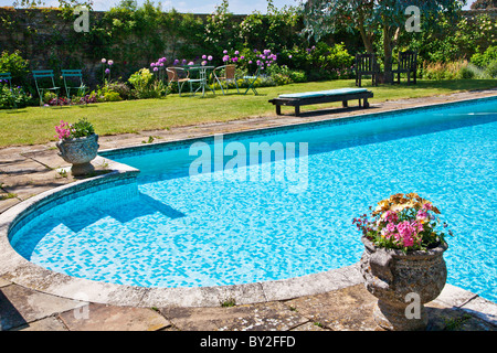 An outdoor swimming pool in an English country summer garden Stock Photo