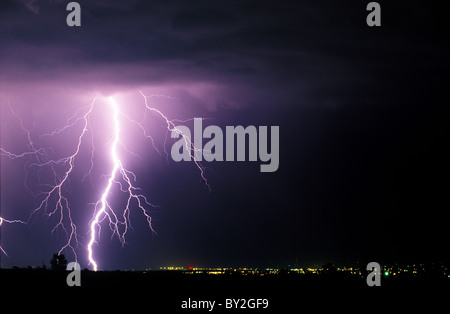 A large lighting bolt lights up the sky as it strikes near Fort Collins Colorado. Stock Photo