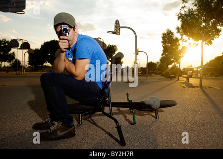 A BMX rider photographed with an old fashioned 16mm video camera in Albuquerque, NM. Stock Photo