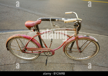 Vintage bicycle locked up on street.